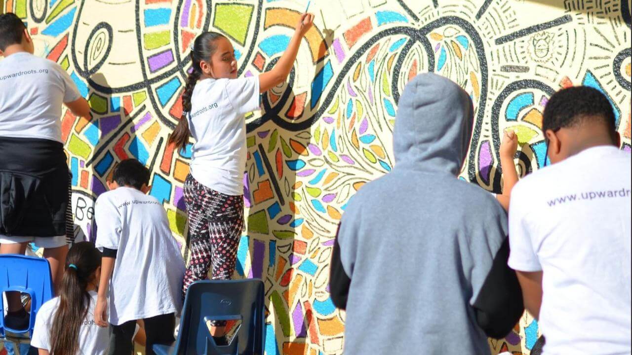 young people painting a wall